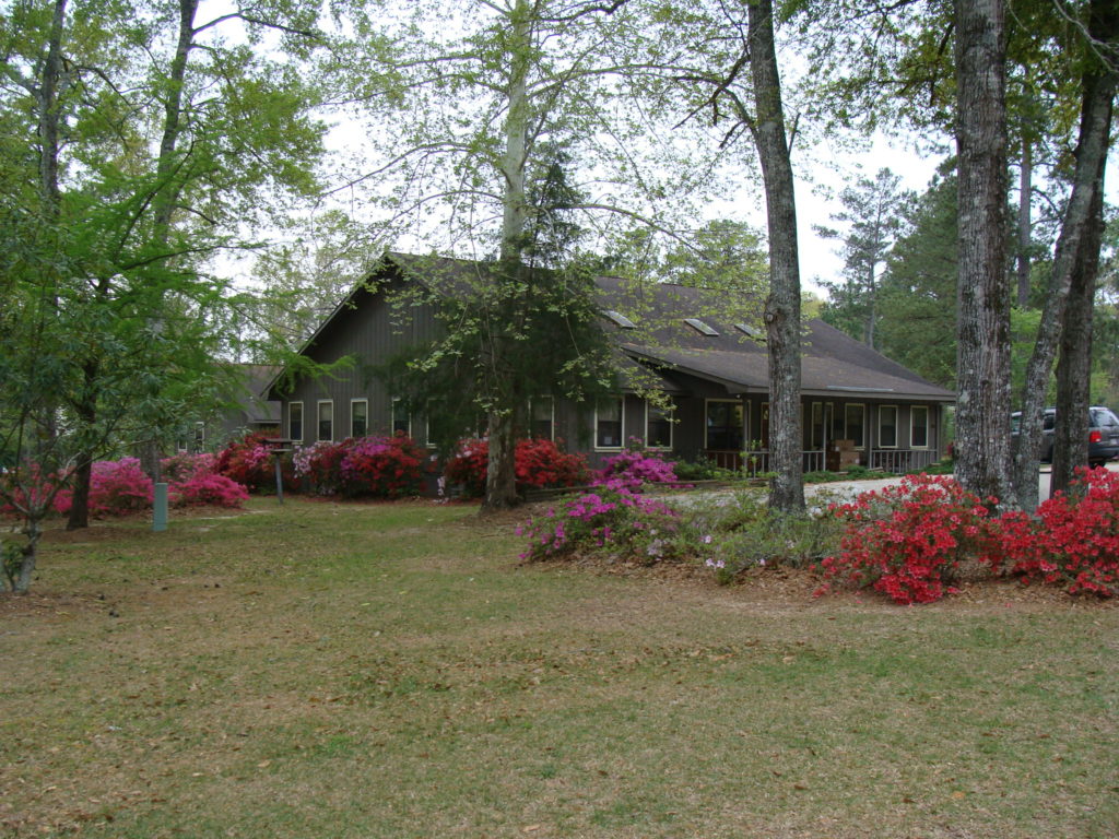 side view of the Martha Dixon Administrative Building with azaleas blooming
