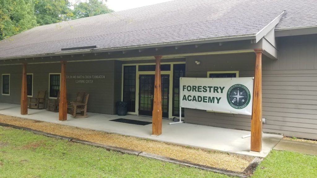 exterior view of the the Solon and Martha Dixon Foundation Learning Center with an Alabama Forestry Commission banner