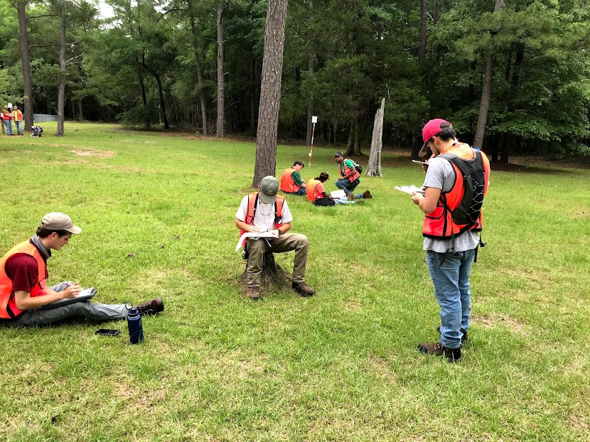Auburn forestry students working on compass and pacing in the recreation field